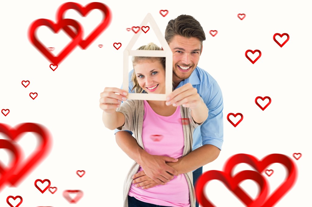 a couple, hugging and holding an outline of a house against a background of hearts
