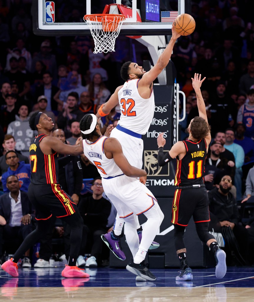 Karl-Anthony Towns blocks a shot by Hawks Trae Young during the fourth quarter.
