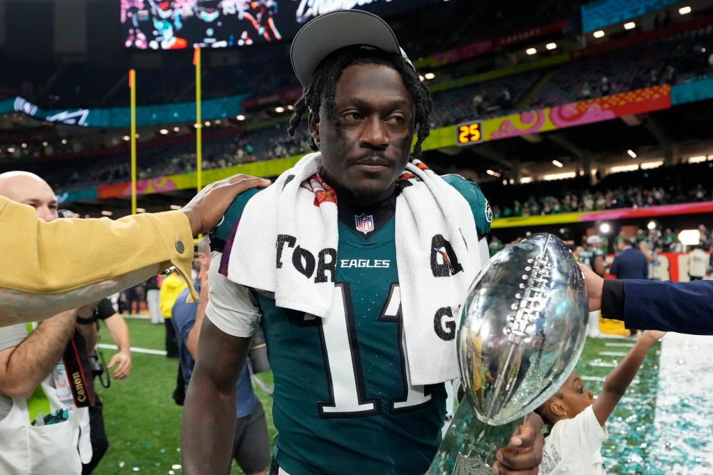 Philadelphia Eagles wide receiver A.J. Brown carries the Vince Lombardi Trophy after the NFL Super Bowl 2025 football game against the Kansas City Chiefs, Sunday, Feb. 9, 2025, in New Orleans. 