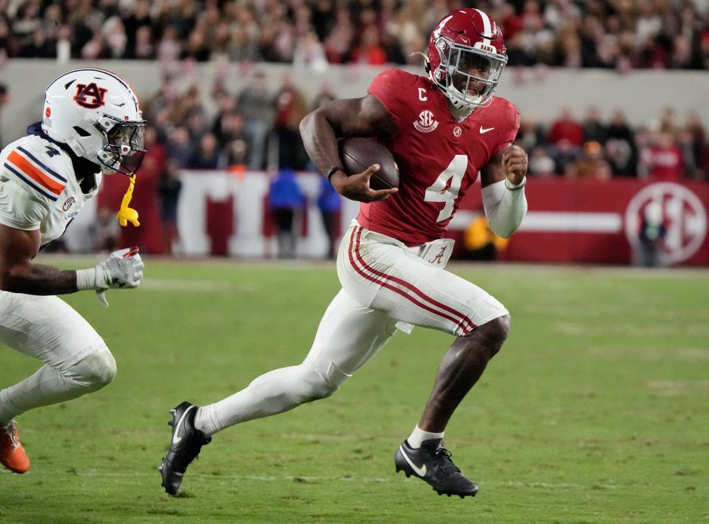 Alabama Crimson Tide quarterback Jalen Milroe (4) running for a touchdown against Auburn Tigers cornerback Kayin Lee (4) during a game at Bryant-Denny Stadium