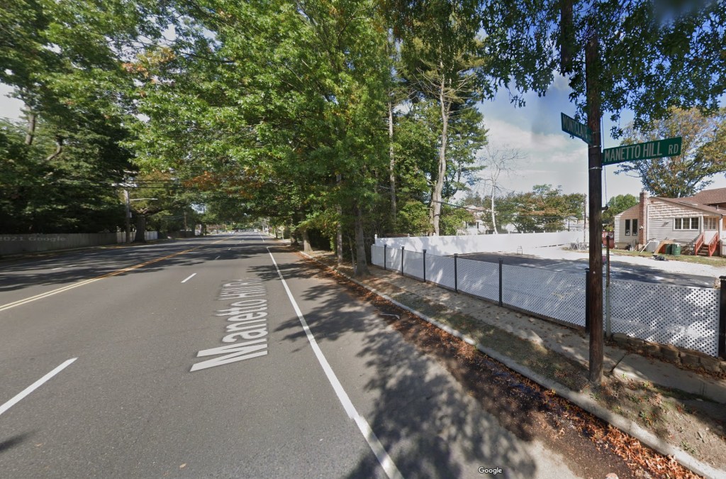 Street sign reading 'Captain Omer Neutra Way' on Manetto Hill Road in Plainview, Long Island
