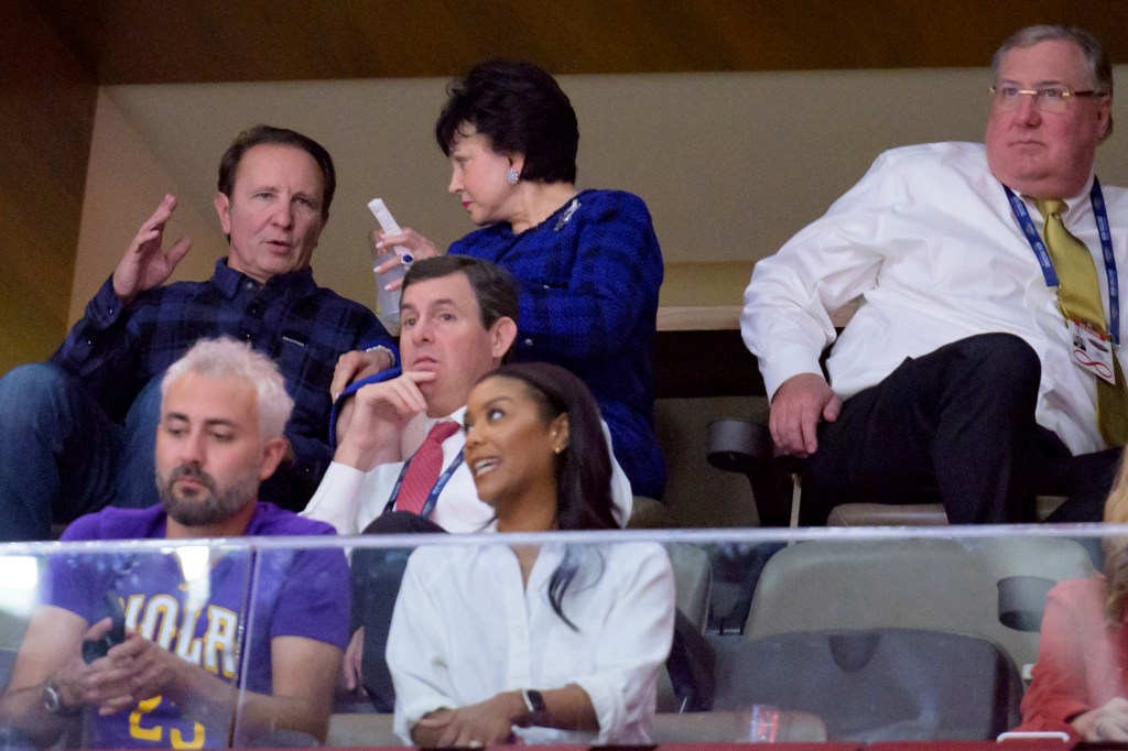 New Orleans Pelicans owner Gayle Benson in conversation with Louisiana Gov. Jeff Landry and team officials during a basketball game against the Atlanta Hawks