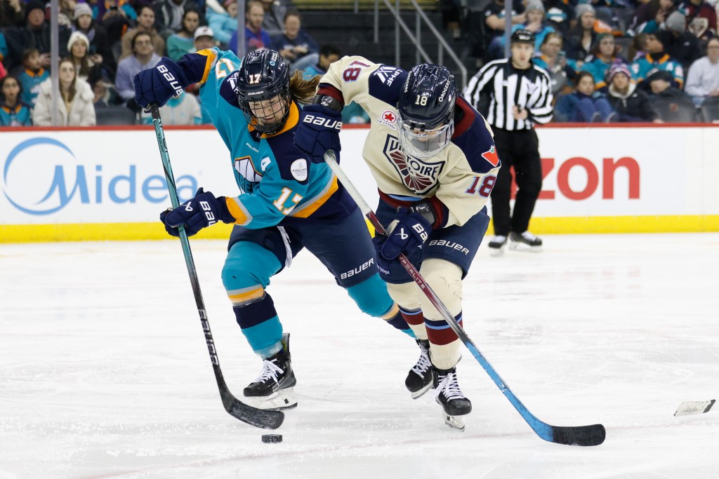 New York Sirens Ella Shelton and Montréal Victoire Mikyla Grant-Mentis fight for control of the puck during the third period. The Montréal Victoire defeated the New York Sirens 2-1 at the Prudential Center, Sunday, Feb. 2, 2025, in Newark, NJ. 