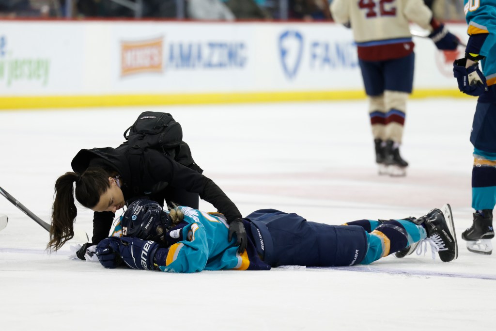 New York Sirens Jade Downie-Landry is checked on by a trainer during the second period at the Prudential Center, Sunday, Feb. 2, 2025, in Newark, NJ. 