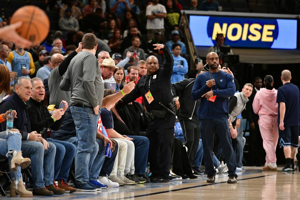 A police officer motions for help as a man has a medical emergency before an NBA basketball game between the San Antonio Spurs and the Memphis Grizzlies Monday, Feb. 3, 2025