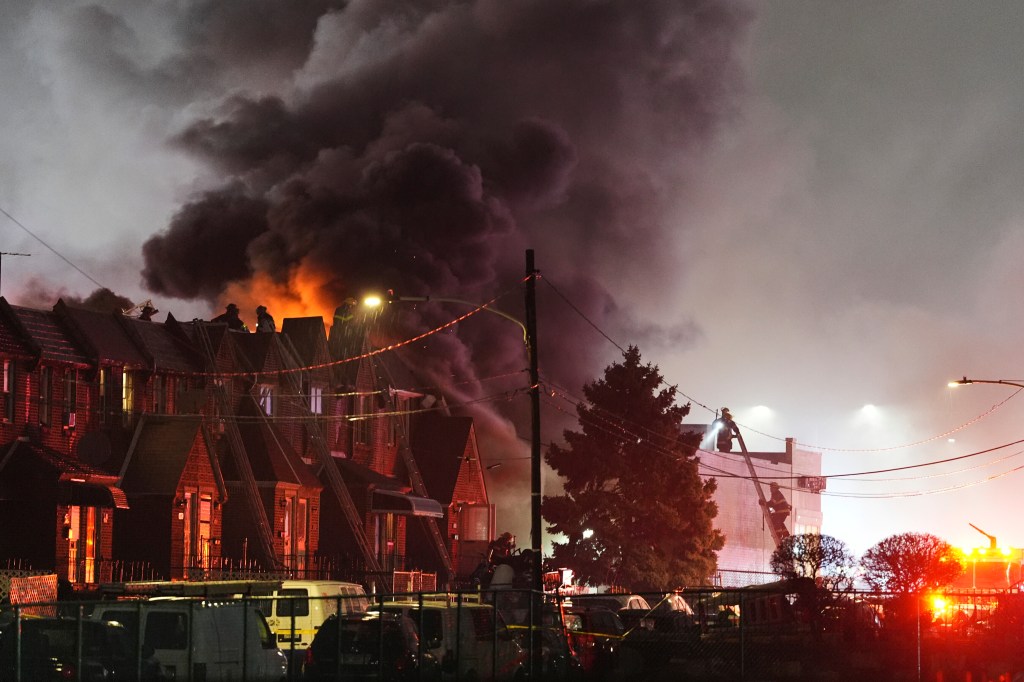 First responders at the scene of a small plane crash with rising smoke in Philadelphia on Jan 31, 2025