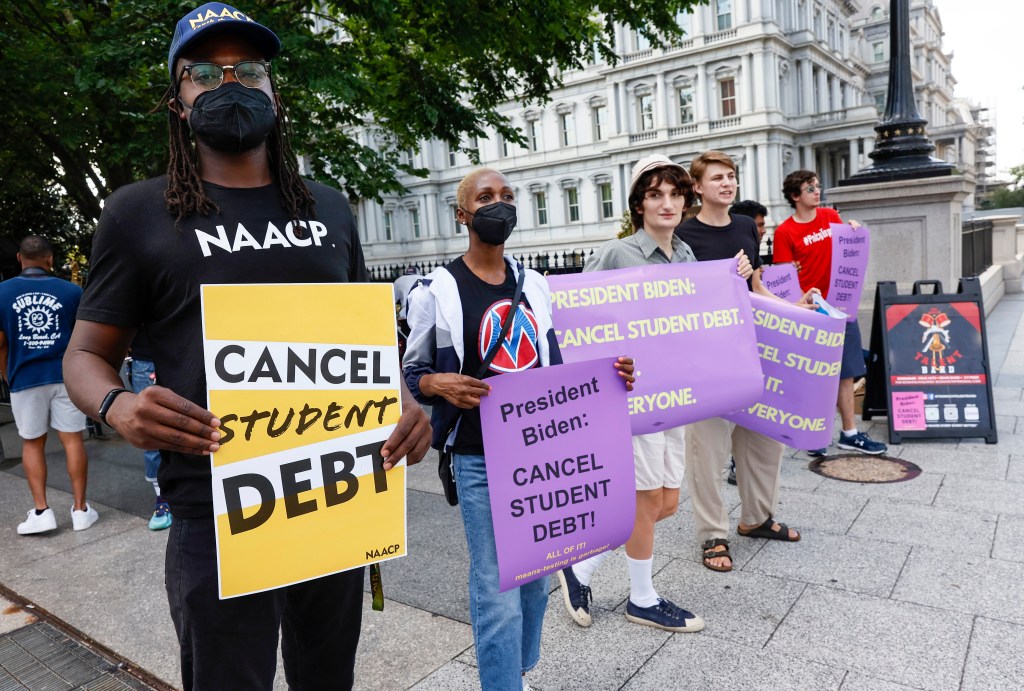 Student loan debt holders take part in a demonstration outside of the white house staff entrance to demand that President Biden cancel student loan debt in August on July 27, 2022 at the Executive Offices in Washington, DC.