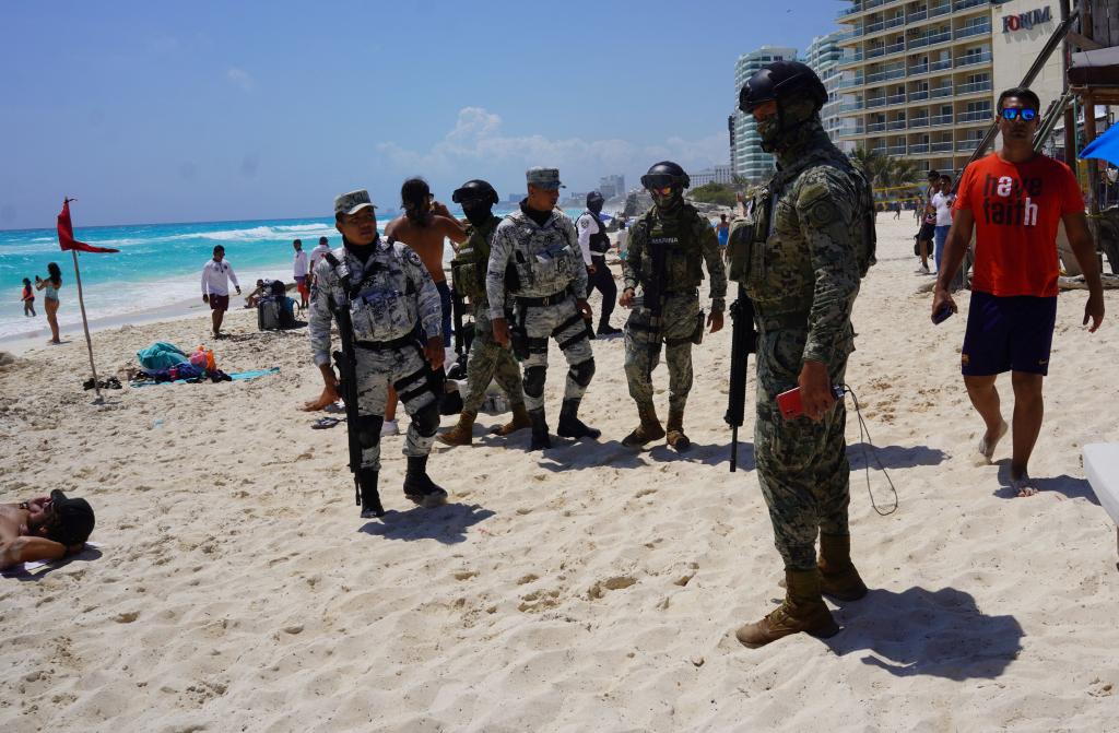 Mexican military members patrolled Cancun beaches during spring break.