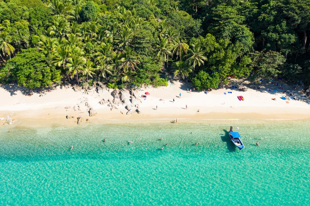 Banana Beach on the Thai island of Phuket came in second place globally. Here, view from above of a beautiful tropical beach with white sand, turquoise clear water, long-tail boat and people sunbathing, Banana beach, Phuket, Thailand.