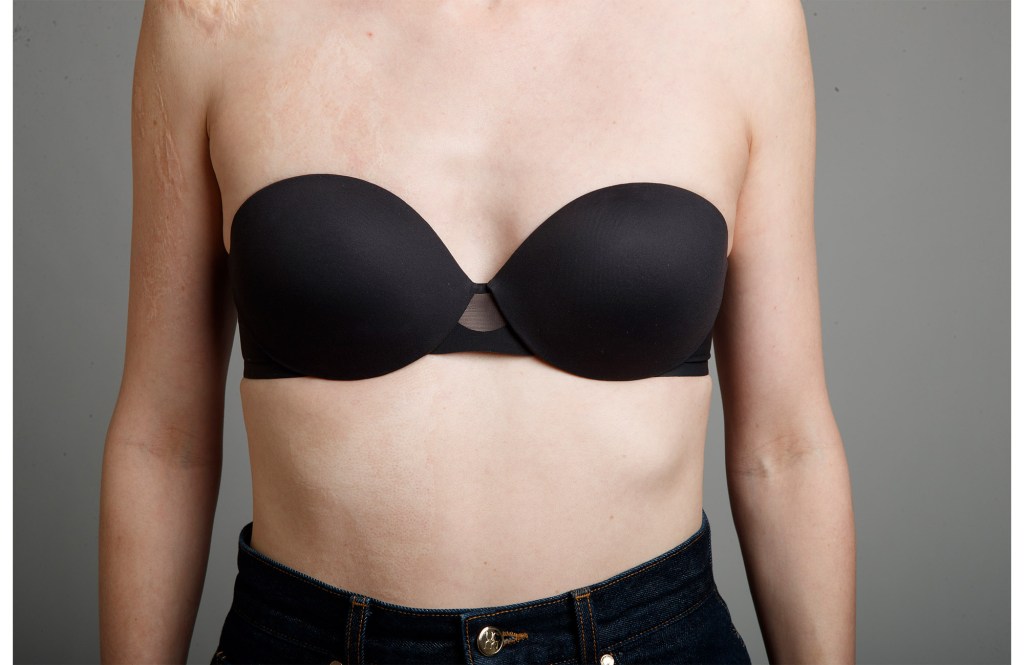 A woman wearing a black Maidenform strapless bra 