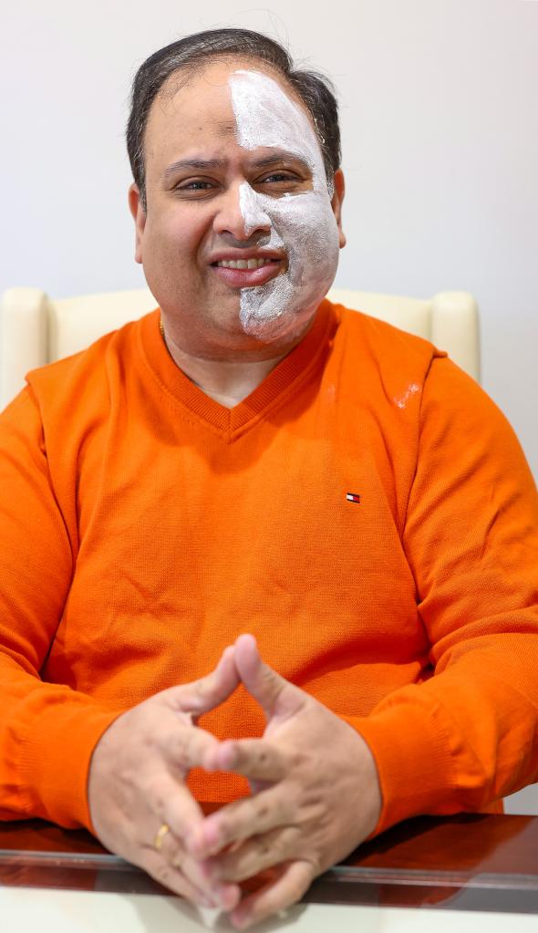 Atul Bhatara, 45 has Cerebral Palsy and started his own skincare line, and is wearing face mask from the line.