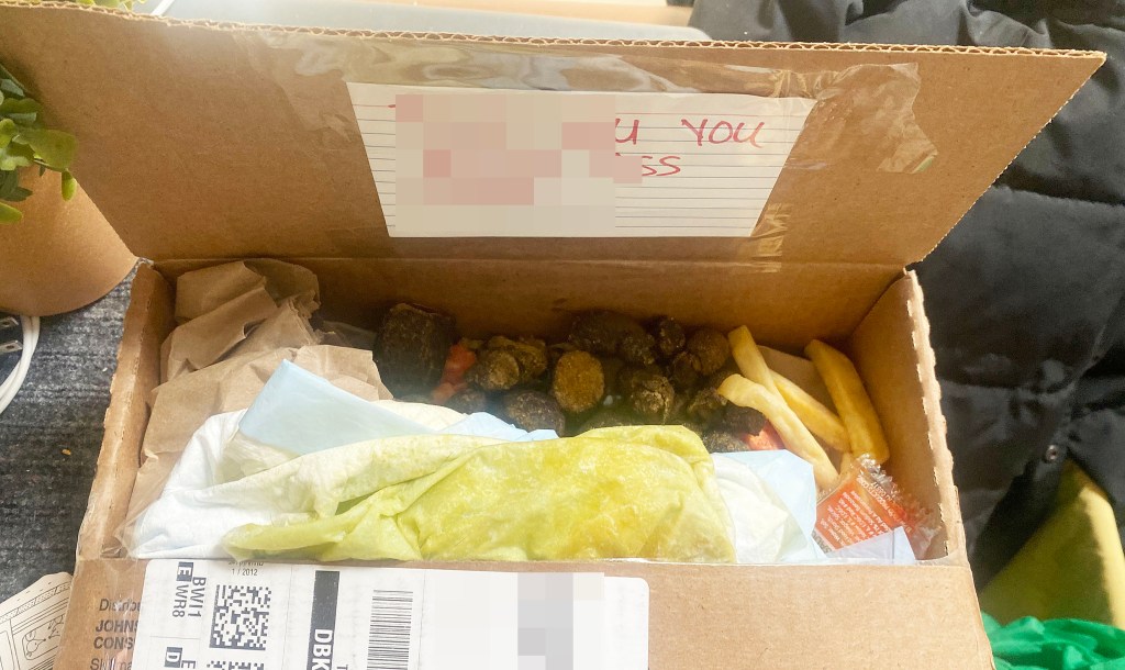 The open decoy box Queens' Carlos Mejia placed on his porched last year to catch thieves. Poop, old food and trash can be seen along with a note to the thieves taped to the inside lid; the message is blurred out
