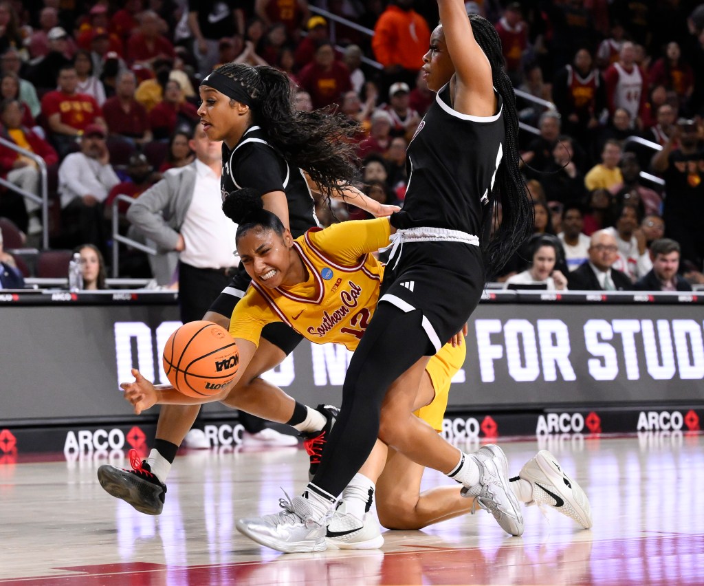 JuJu Watkins grimaces after injuring her knee during the first quarter of USC's game March 25.