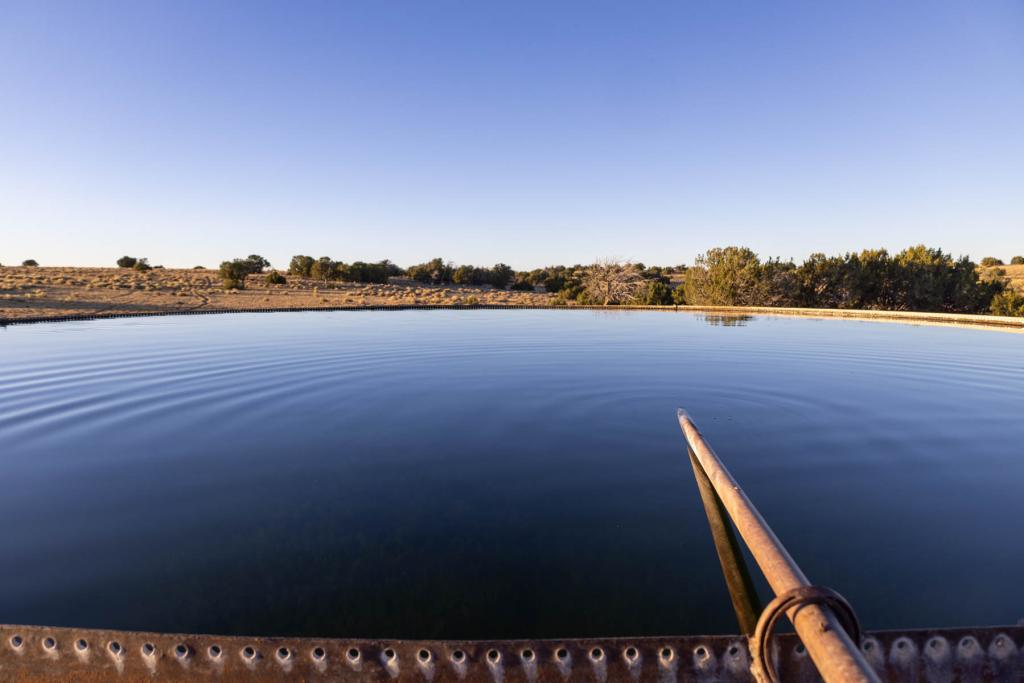 With a remote location 160 miles from Albuquerque, the ranch includes additional residences, barns, and significant water rights, making it a rare find.