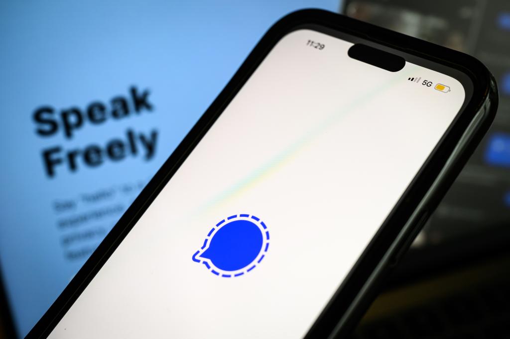 Mobile device showing Telegram company logo and laptop displaying messaging app webpage in Copenhagen, Denmark on March 25, 2025