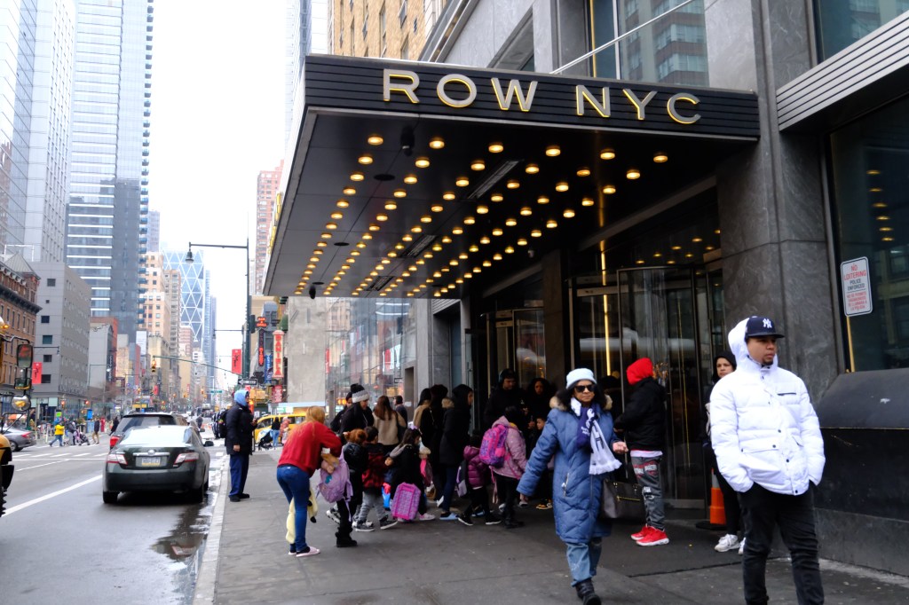 School-age children are dropped off by a school bus at the Row Hotel on Eighth Avenue between 44th and 45th Streets in Midtown Manhattan on Wednesday, February 12, 2025.