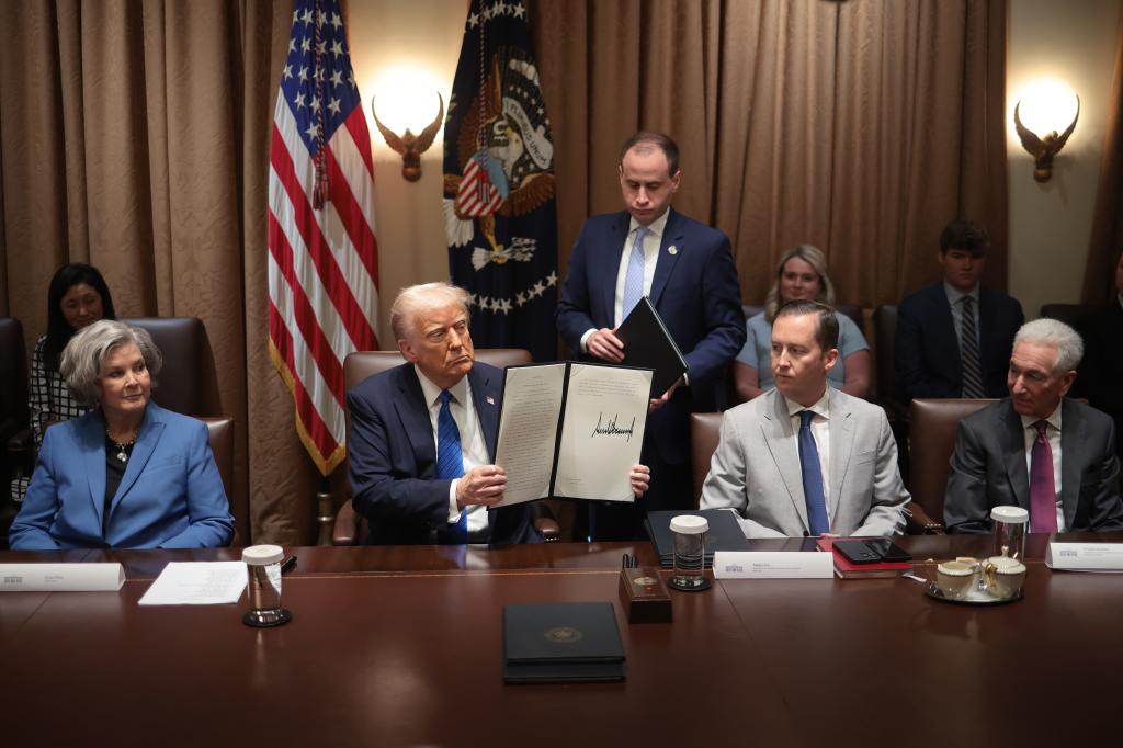 U.S. President Donald Trump holding an executive order at Ambassador Meeting in the Cabinet Room of the White House with Chief of Staff Susie Wiles, Sergio Gor, and Charles Kushner.