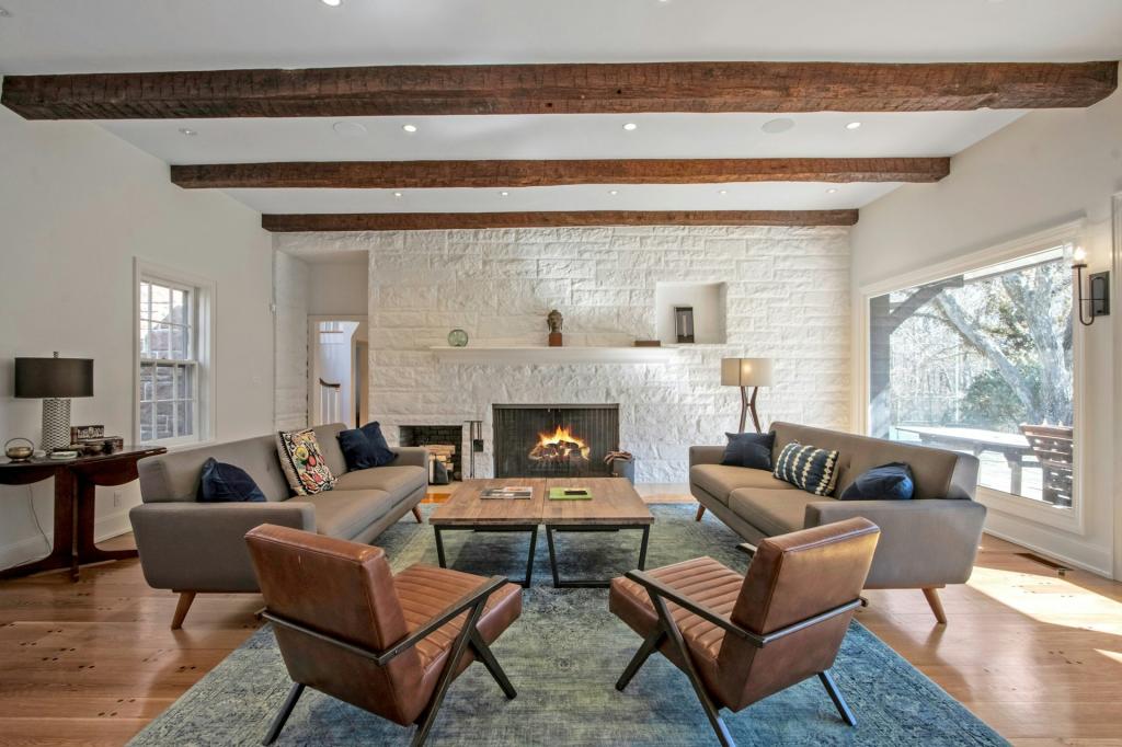 Beamed ceilings and a fireplace add to the room's charm