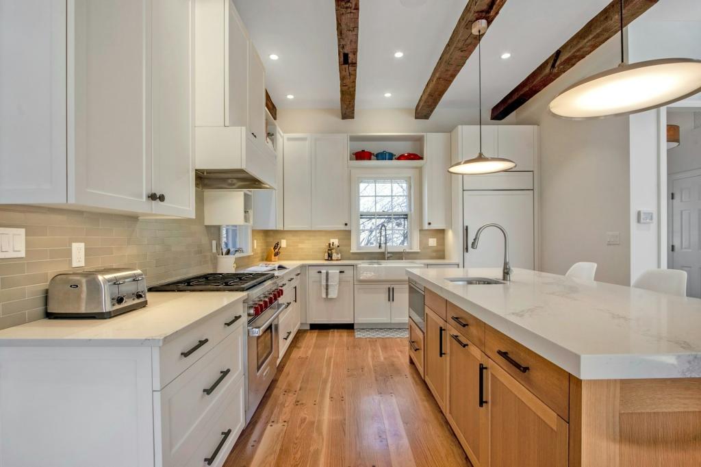 The compact kitchen features beamed ceilings and high end equipment
