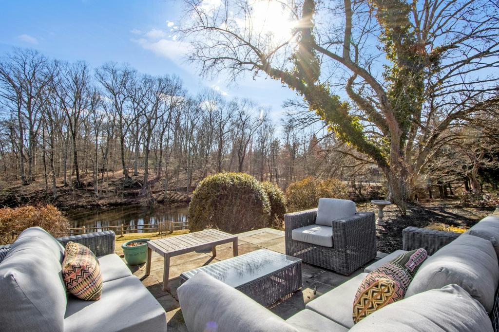 Mid-century Mountain View Farmhouse on a 6.5 acre estate with a patio furnished for entertaining overlooking a river.