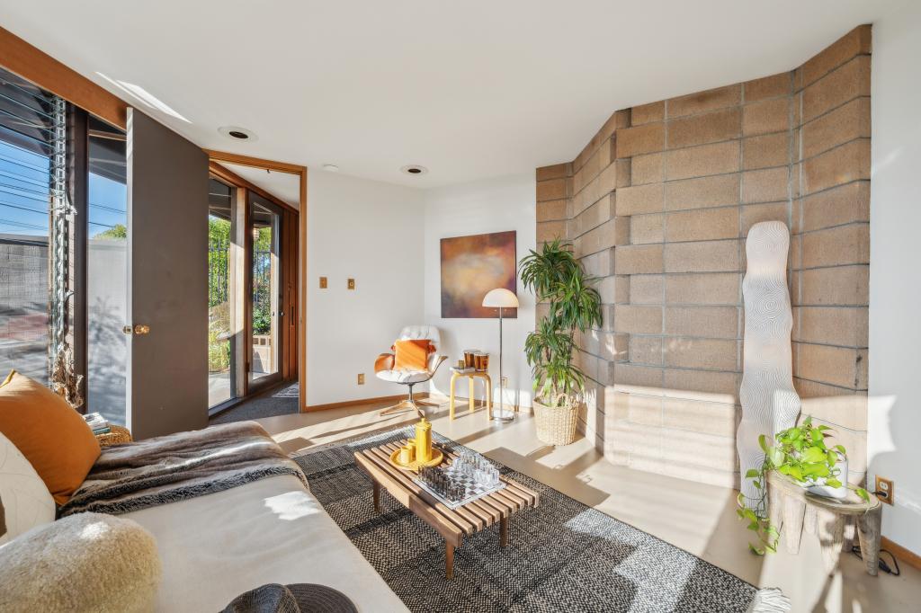 The home features redwood walls, refinished oak floors, a copper fireplace. 
