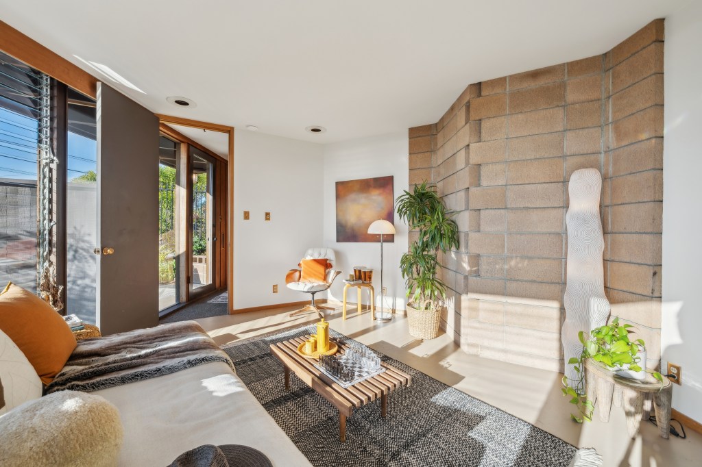 The home features redwood walls, refinished oak floors, a copper fireplace. 