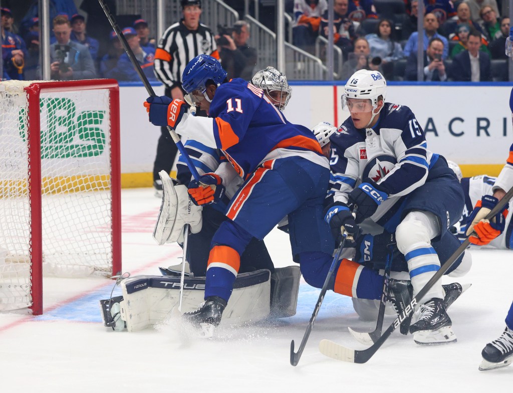 Anthony Duclair (11) charges the net in an attempt to score on Connor Hellebuyck during the Islanders' win over the Jets.