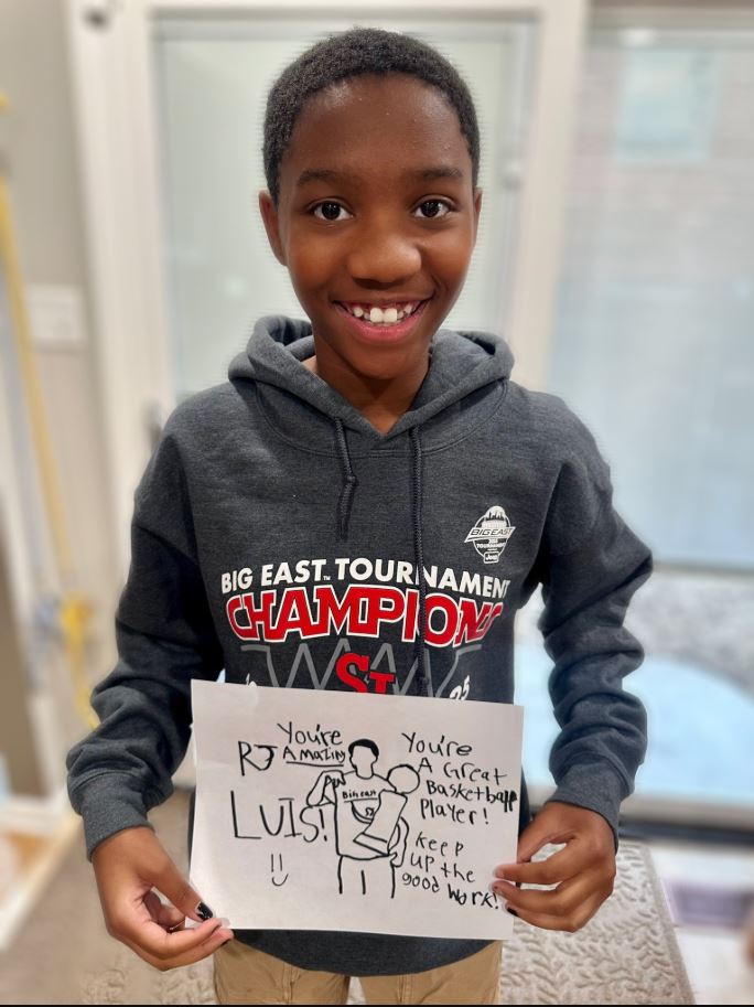 St. John's "Mini Fan" sends word of encouragement to R.J. Luis. 