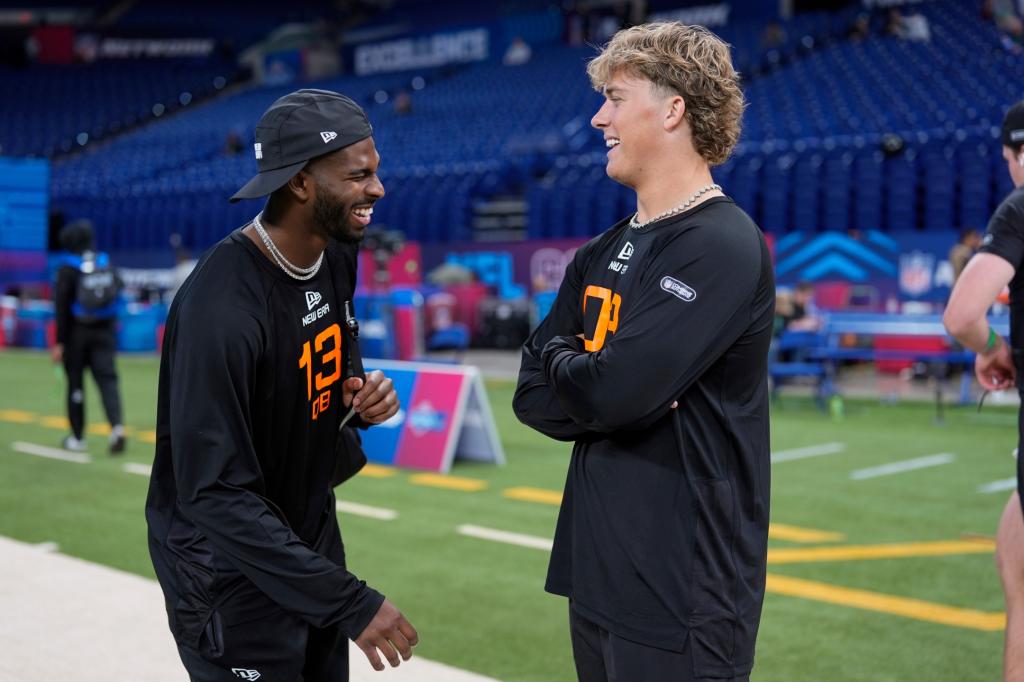 Colorado quarterback Shedeur Sanders laughs with Mississippi quarterback Jaxson Dart at the NFL football scouting combine in Indianapolis, Saturday, March 1, 2025.