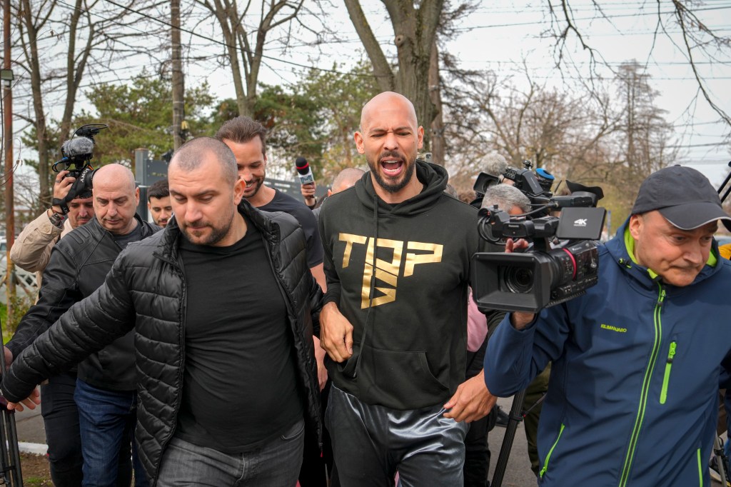 Andrew Tate speaking to media at a police station in Voluntari, Romania, after his return from the United States