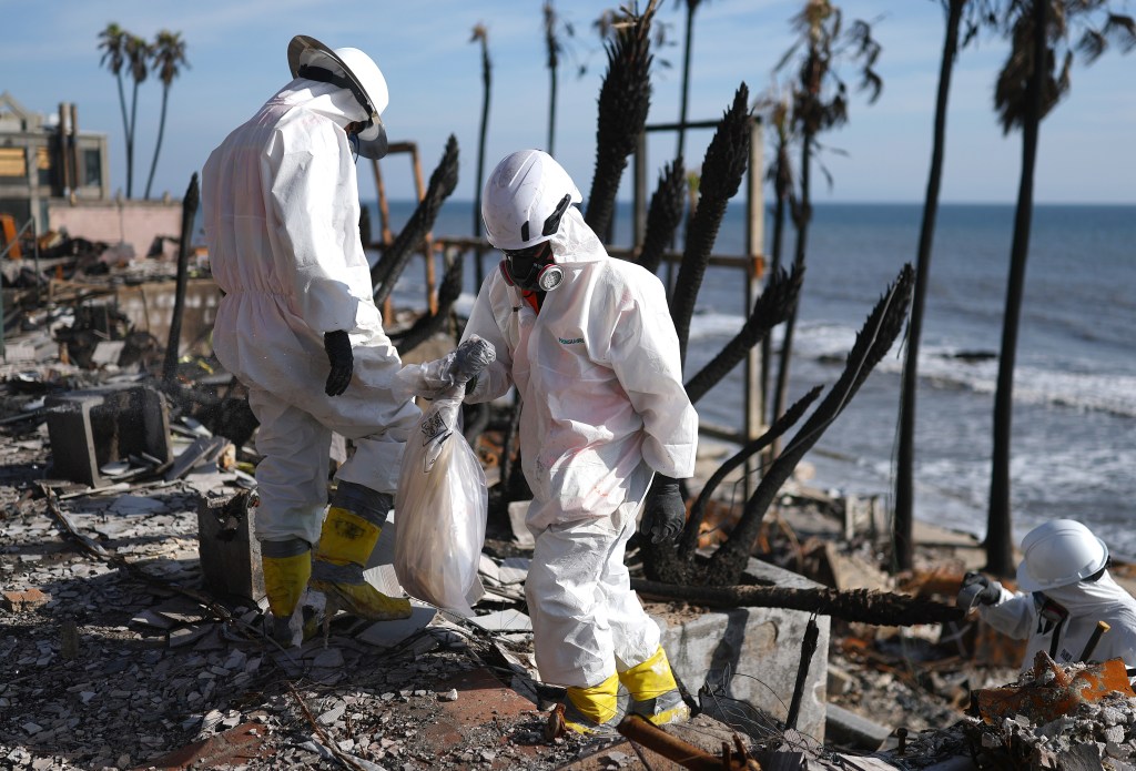 Environmental Protection Agency (EPA) contractors work to remove hazardous waste from beachfront properties destroyed in the Palisades Fire along the Pacific Ocean on February 18, 2025 in Malibu, California.