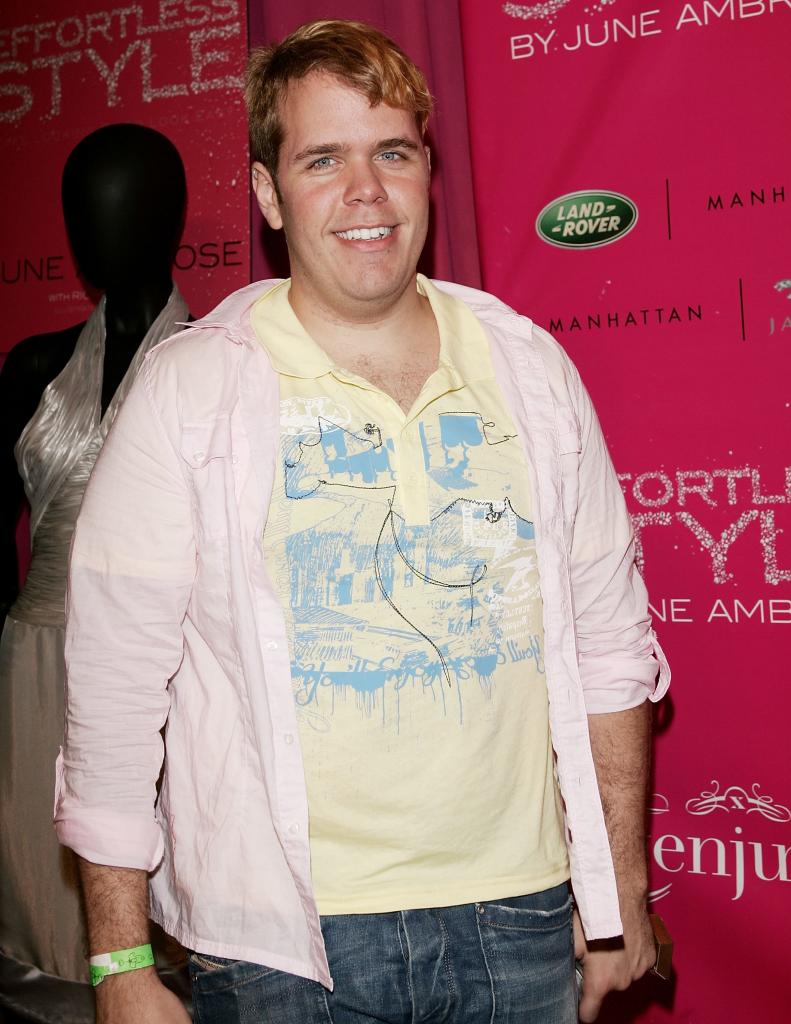 An overweight Perez Hilton smiles on the runway in August 2006.