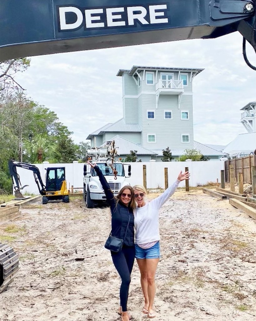 Michele Poole and Katherine Hill standing near construction of their beachhouse
