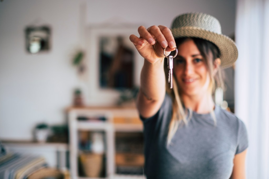 Crop close up of female tenant renter show praise house keys moving to first own new apartment or house