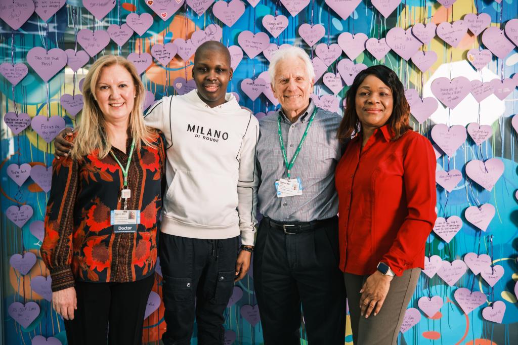 Dr. Banu Aygun, Sebastien Beauzile, Dr. Lipton, and Magda Lamour posing for a photo at Cohen Children's Medical Center after Beauzile's innovative sickle cell disease treatment