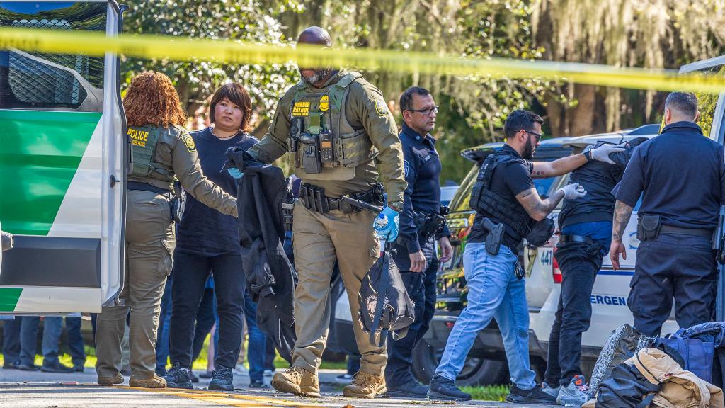 Law enforcement officers detaining migrants in Coral Gables, Florida on January 28, 2025.