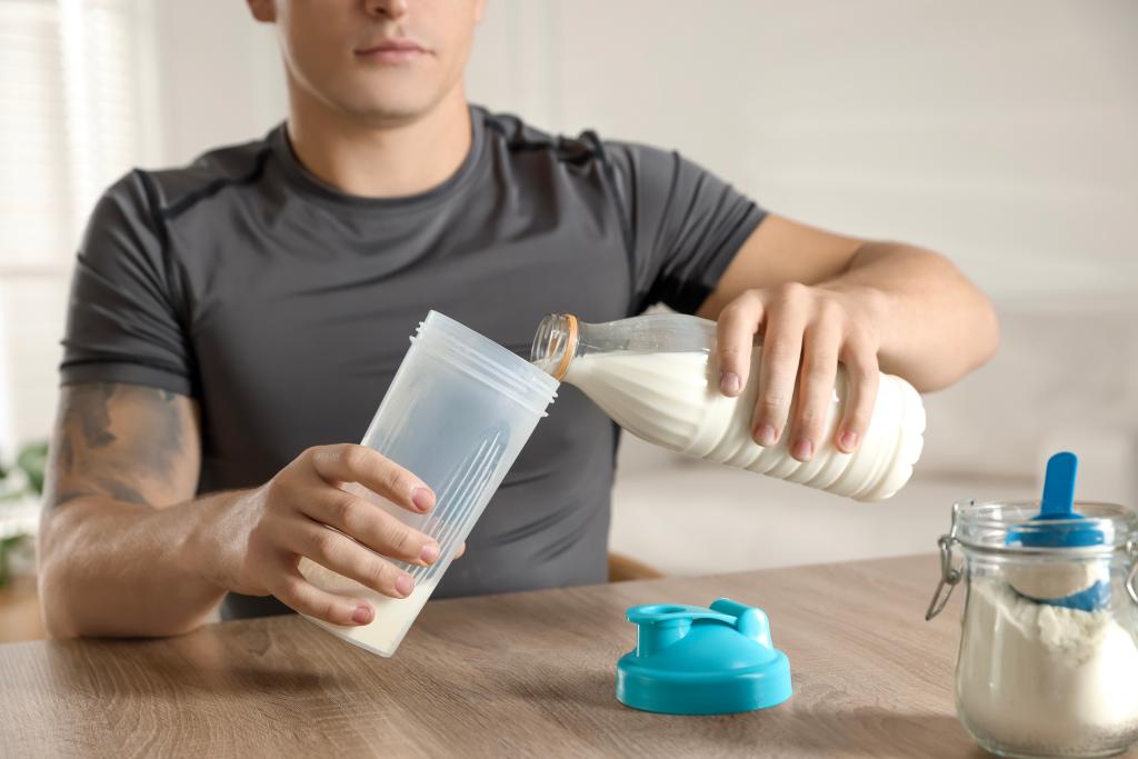 Man drinking milk at desk