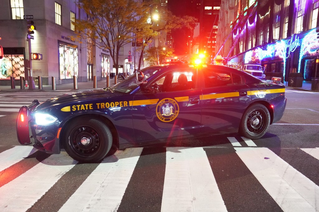 New York State Trooper vehicle parked on a street in New York City, related to a recent highway chase incident