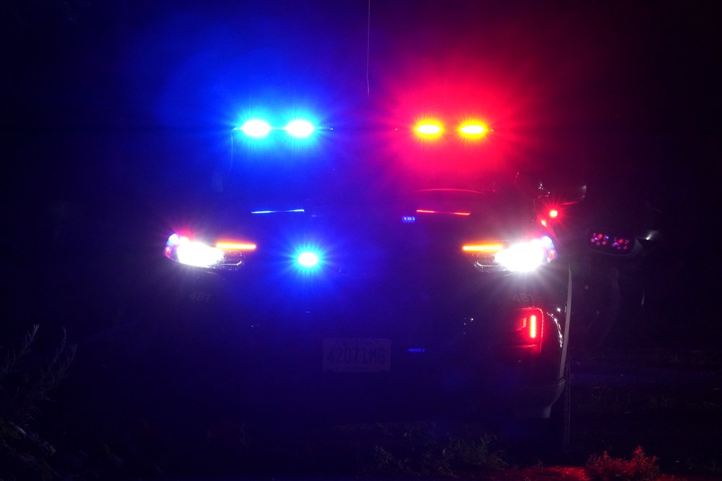 Police car with illuminated blue and red lights at night in West Milford, NJ on June 15, 2024.