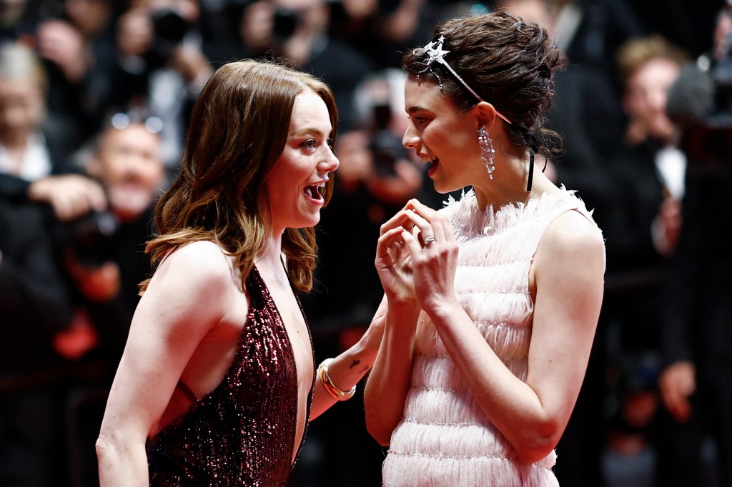 US actress Emma Stone (L) reacts next to US actress Margaret Qualley after the screening of the film "Kinds of Kindness" at the 77th edition of the Cannes Film Festival in Cannes, southern France, on May 17, 2024. 