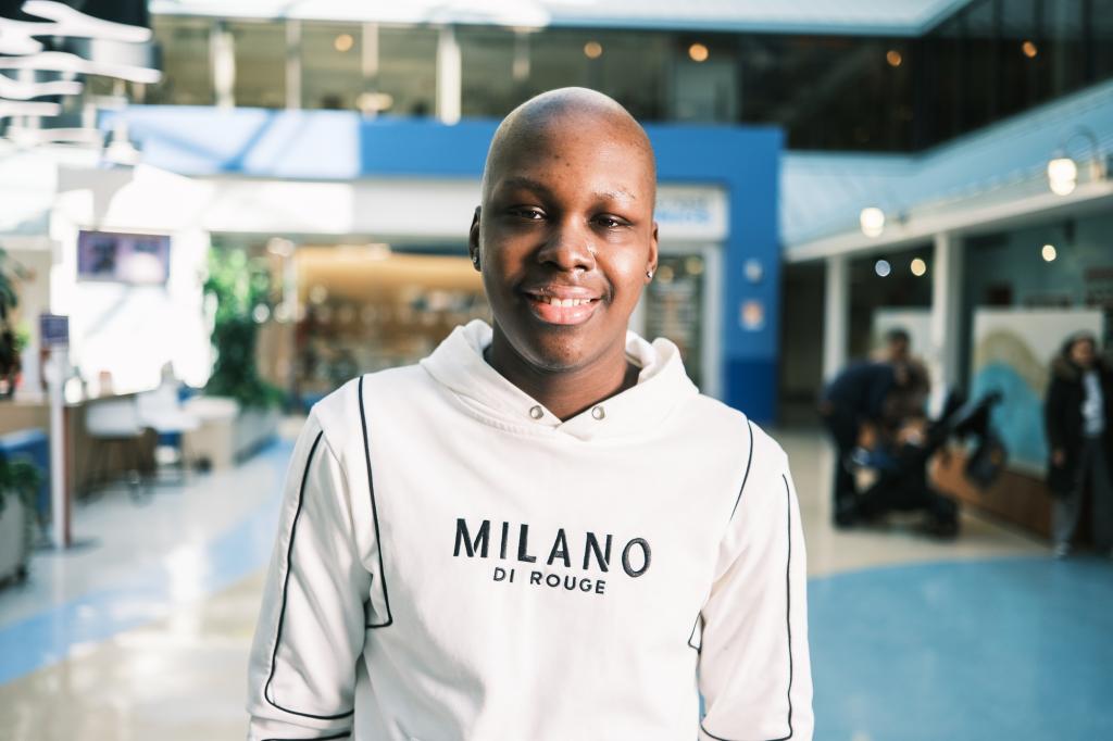 Sebastien Beauzile, 21, smiling at the camera after receiving Lyfgenia gene therapy treatment for sickle cell anemia at Northwell’s Cohen Children Center