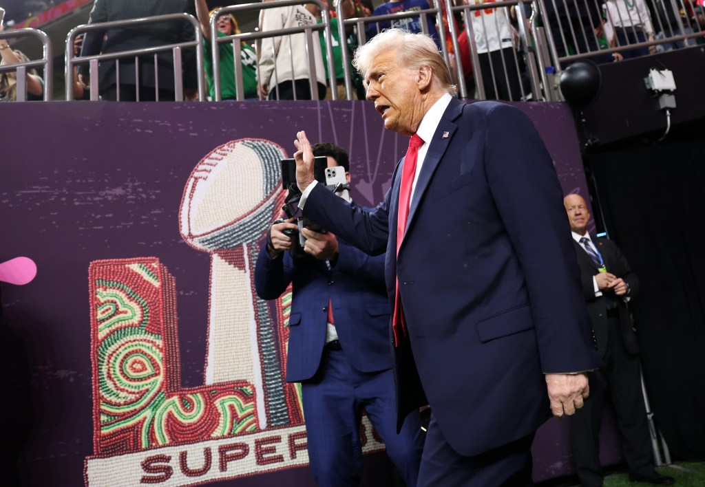 President Donald Trump walks on the field prior to Super Bowl LIX.