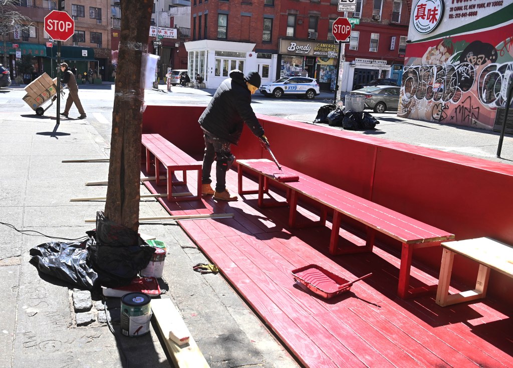 Workers constructing a new outdoor dining shed outside Le Dive Wine Bar in New York