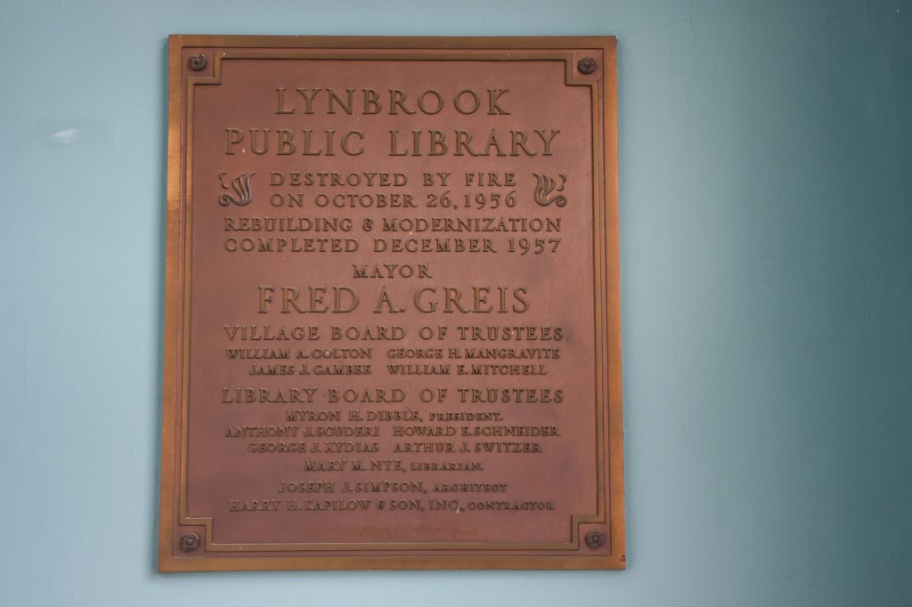 A plaque commemorating the fire set in the Lynrbook Library by a custodian in 1956.