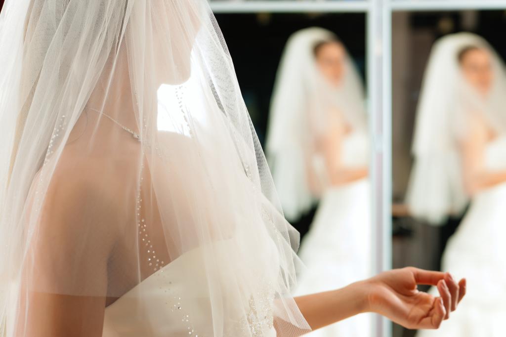 Bride trying on a white wedding dress in a bridal shop
