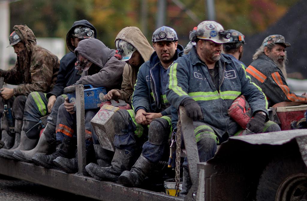 In this Oct. 15, 2014 photo, coal miners return on a buggy after working a shift underground at the Perkins Branch Coal Mine in Cumberland, Ky.