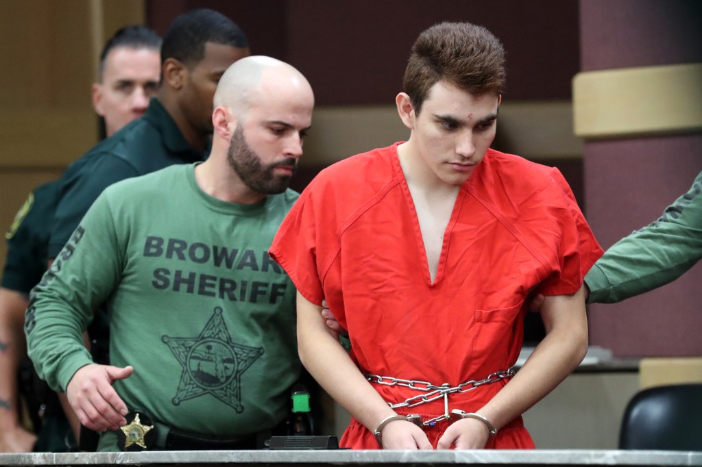 Nikolas Cruz, in handcuffs, being escorted into the courtroom for his arraignment for the Parkland High School shooting in March 2018.