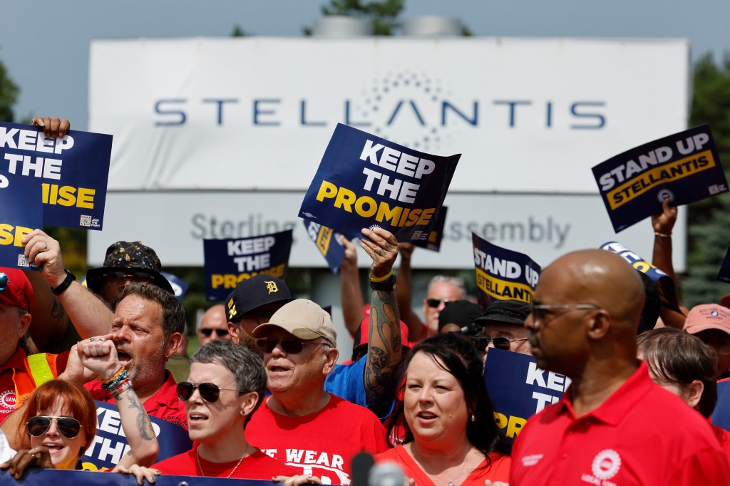 UAW members holding signs at a rally outside the Stellantis Sterling Heights Assembly Plant in Michigan, US, featuring Anslem Douglas, Chrissy Metz, Rick Trevino, Dick Damron, Uri Gavriel.