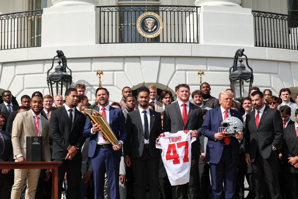 Donald Trump and JD Vance pose with the Ohio State football team after Vance's trophy mishap.