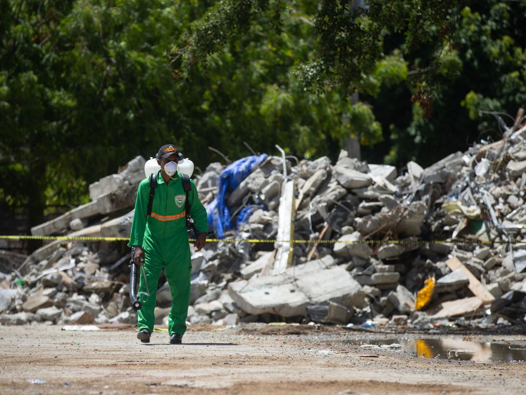 A person works to fumigate the debris from the collapsed roof of the Jet Set nightclub in Santo Domingo, Dominican Republic, 12 April 2025. 